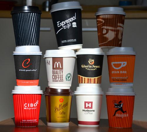 Coffee cups stacked on top of one another from various outlets