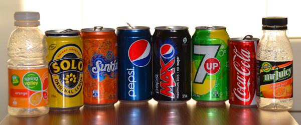 various soft drink and juice cans and bottles