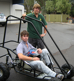 Callum (seated) and Alex (standing) testing the electric vehicle that has been their project focus at the new Riverland Trade Training Centre at the TAFE SA Berri Campus 