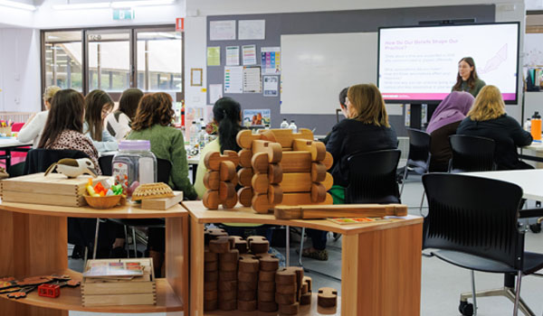 Educator and students in classroom environment