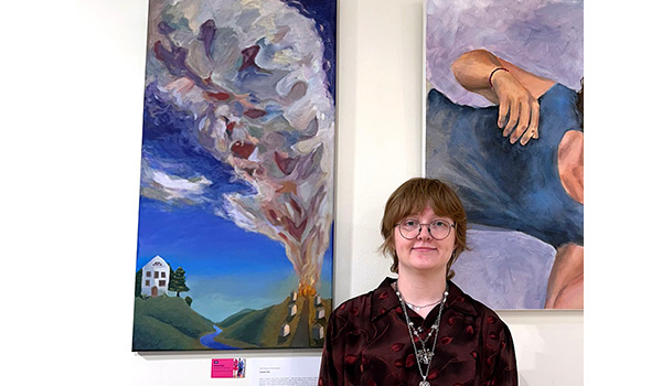 Visual arts student Cassie Holt with her painting.