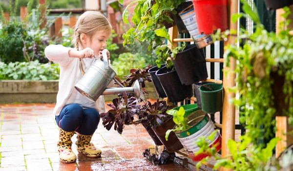 child-watering-plants