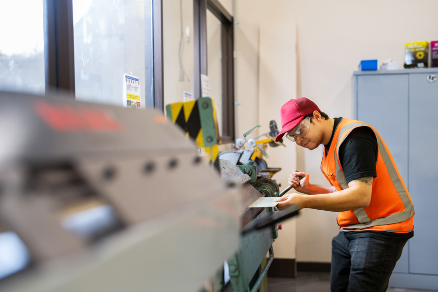student wearing safety glasses using equipment