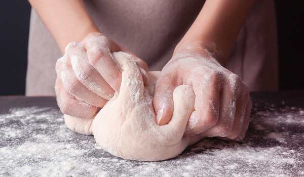 hands kneading dough