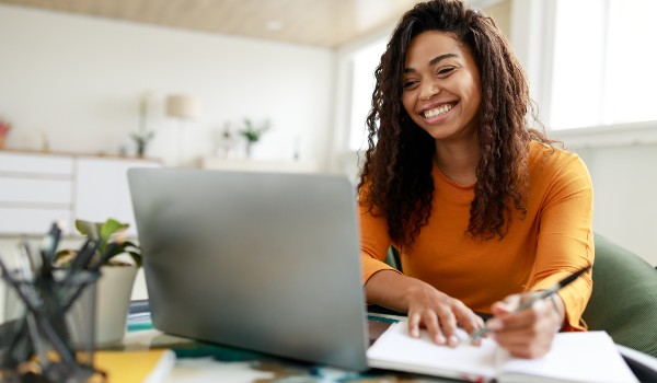 smiling student at laptop