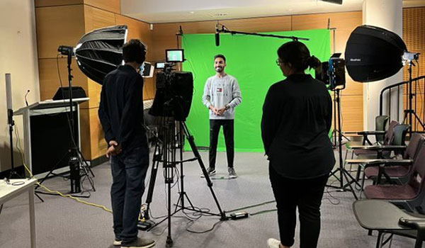 student being recorded by a film crew