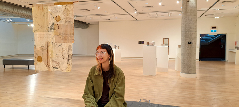 Shani sitting in Light Square Gallery